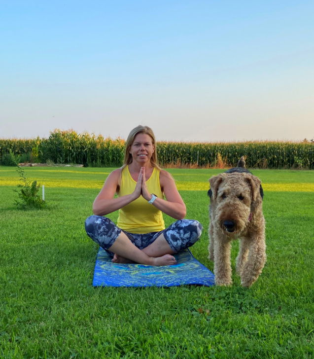 women doing yoga with a dog